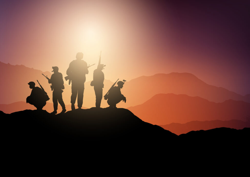 Silhouettes of soldiers on lookout in sunset landscape